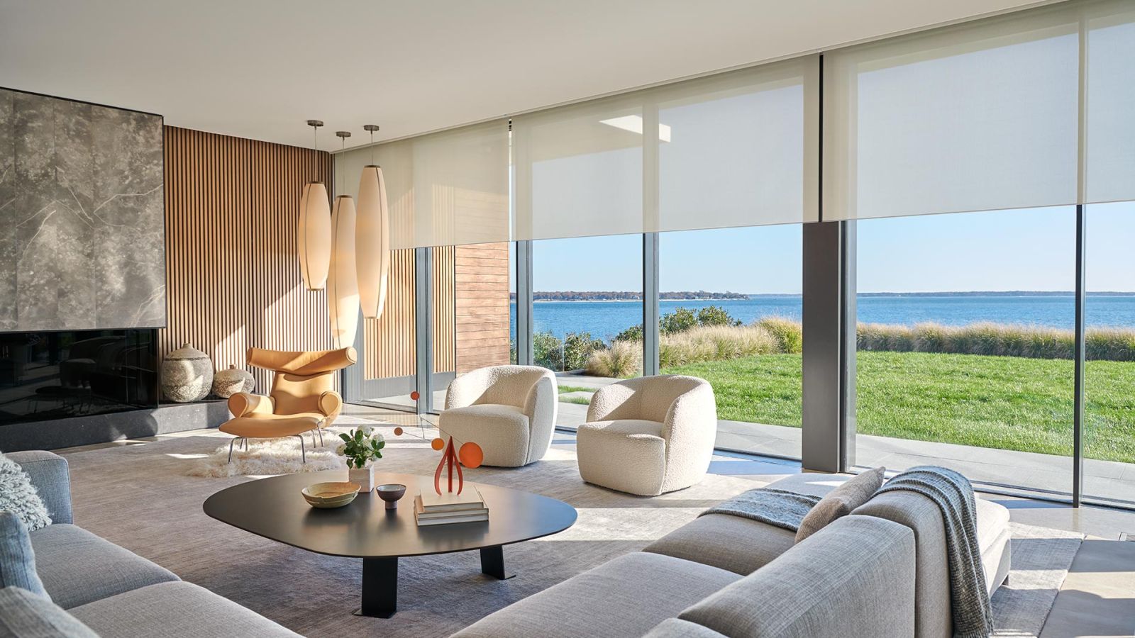 Modern bathroom with marble finishes, freestanding tub, and glass shower enclosure