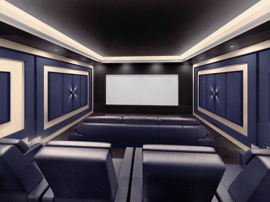 A home theater space featuring seating, in-wall speakers, acoustic paneling, and a large screen display.