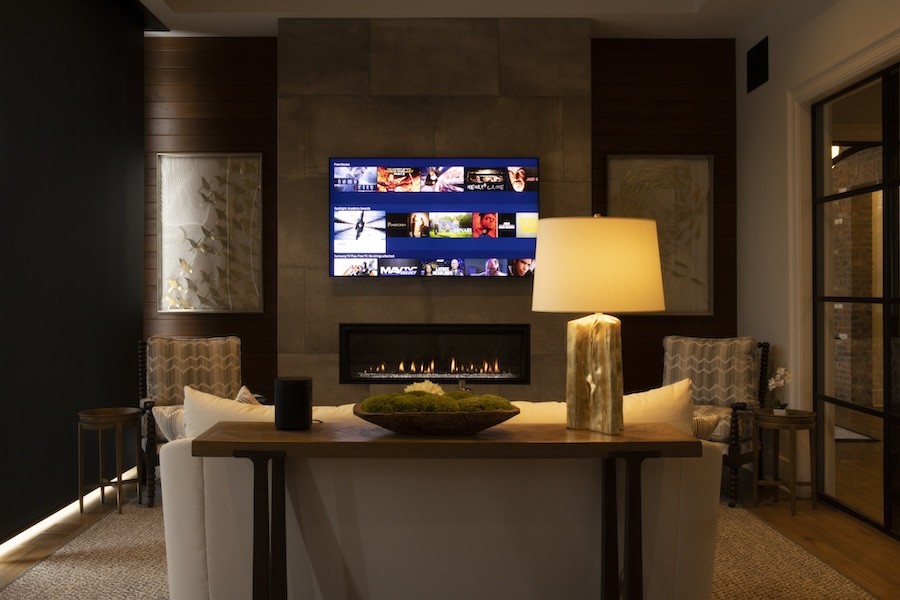 A family room with a TV, fireplace, and dimmed lighting.