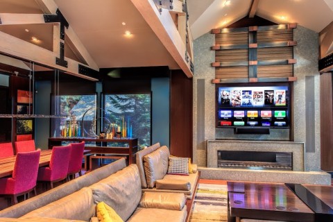 A modern living area with a carefully integrated TV over the fireplace.