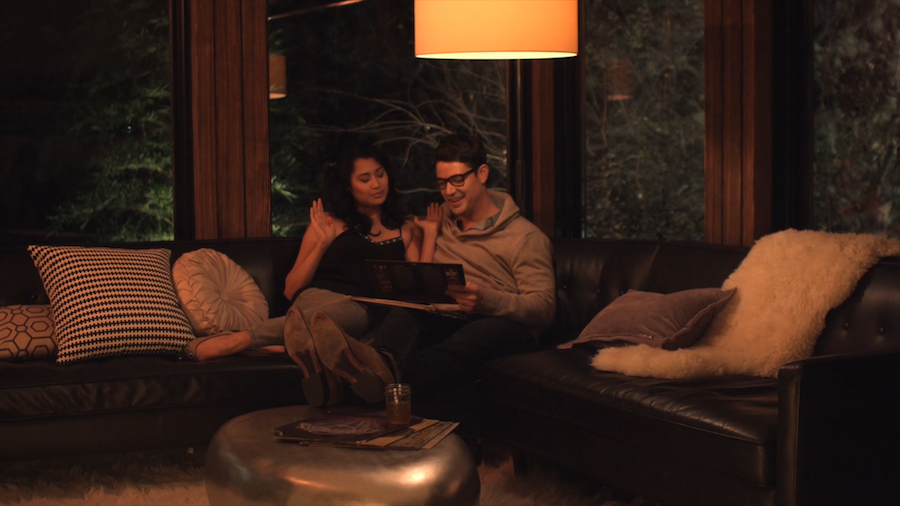 Couple enjoying time on the couch with their dimmed Ketra lighting.