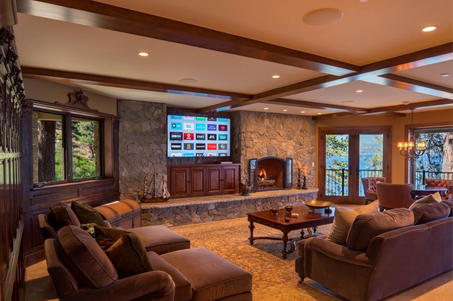 A living room with in-ceiling speakers and a large TV.