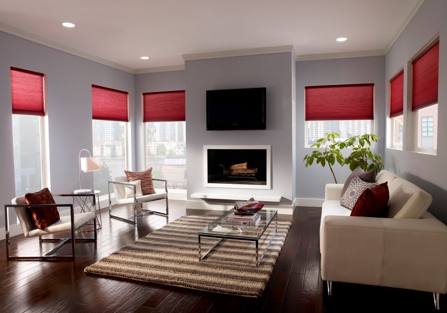 A living room with Lutron’s red motorized shades partially drawn.
